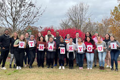 Group of students holding cards that spell "THANK YOU!" and one with the IU logo
